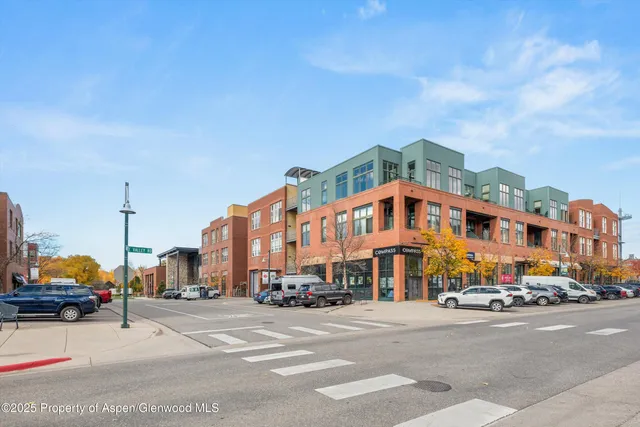 a city street with tall buildings in the background