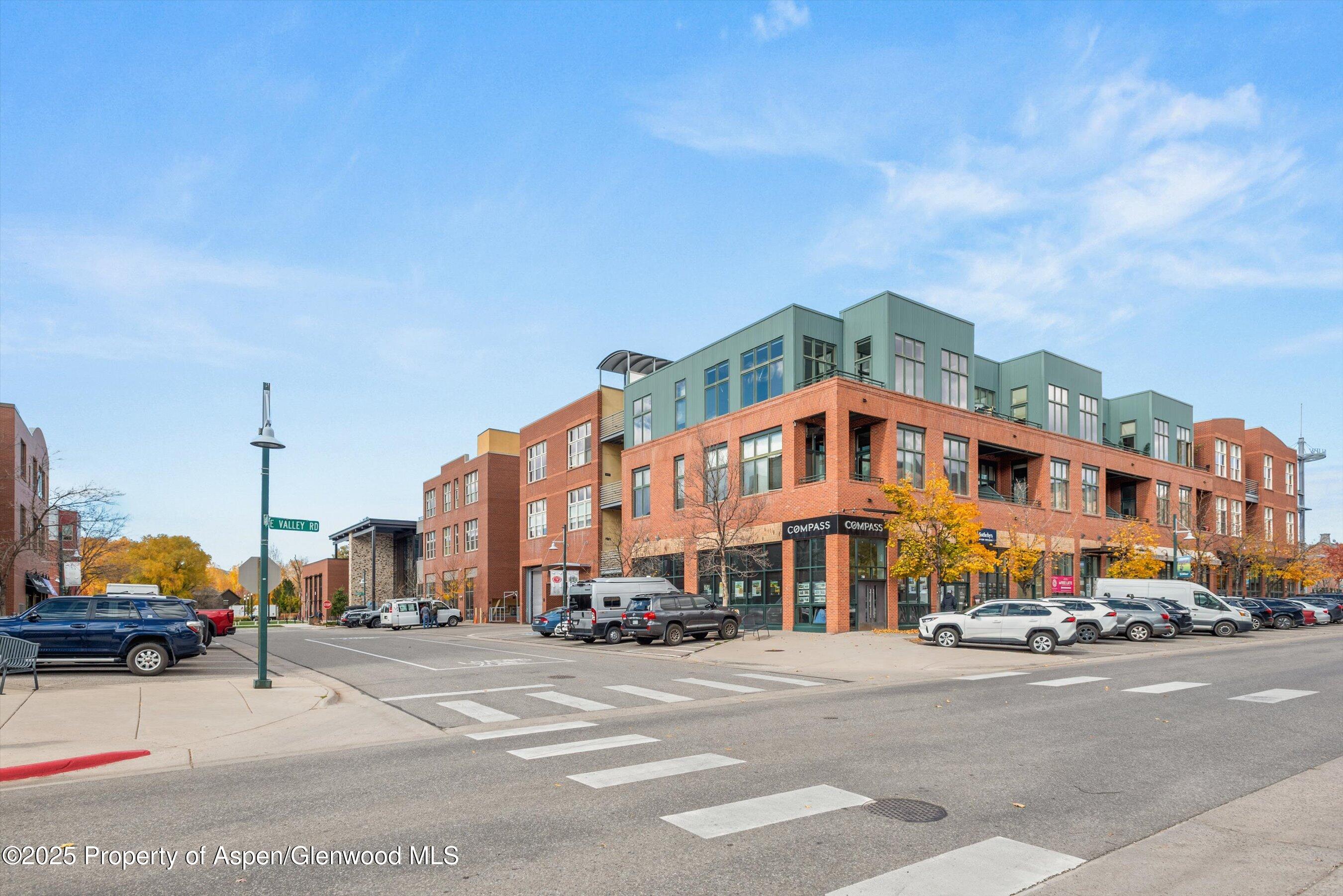 231 Robinson Street, Unit 302 Basalt, CO 81621 - Photo 16 of 17 a city street with tall buildings in the background