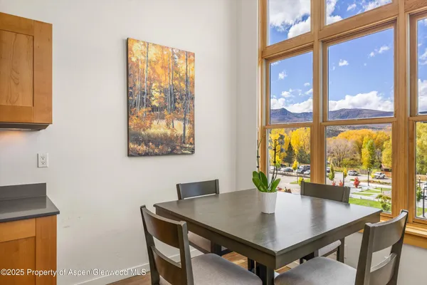a view of a dining room with furniture and window
