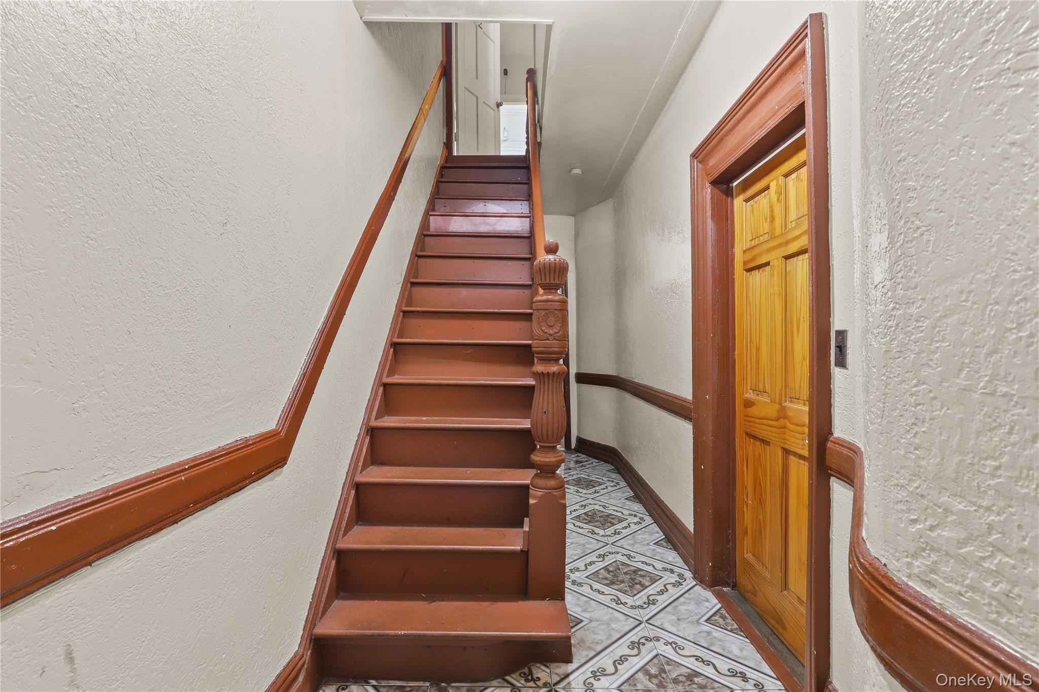 1448 Edwards Avenue Bronx, NY 10461 - Photo 16 of 28 a view of staircase with wooden floor and white walls
