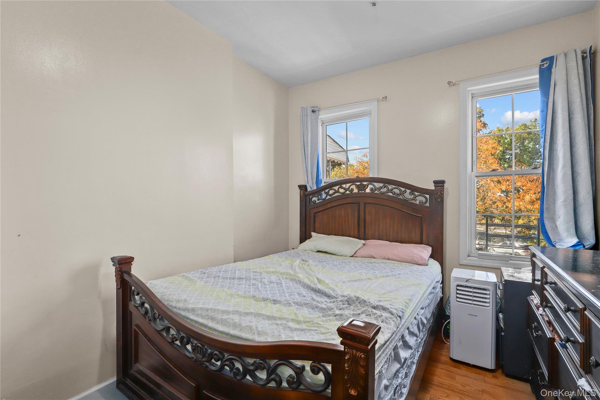 1448 Edwards Avenue Bronx, NY 10461 - Photo 20 of 28 a bedroom with a bed and wooden floor
