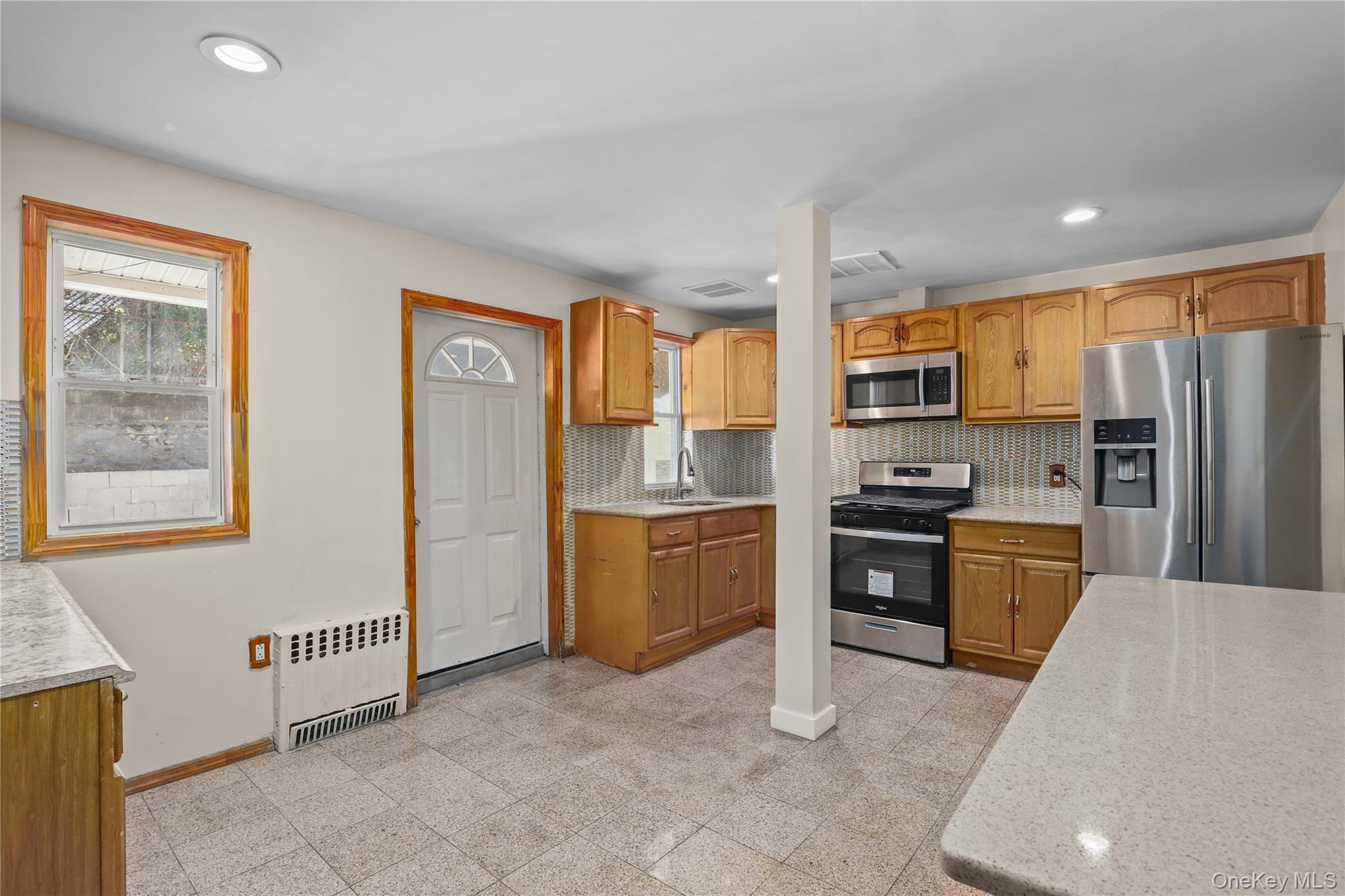 1448 Edwards Avenue Bronx, NY 10461 - Photo 6 of 28 a kitchen with stainless steel appliances granite countertop a refrigerator stove top oven and sink