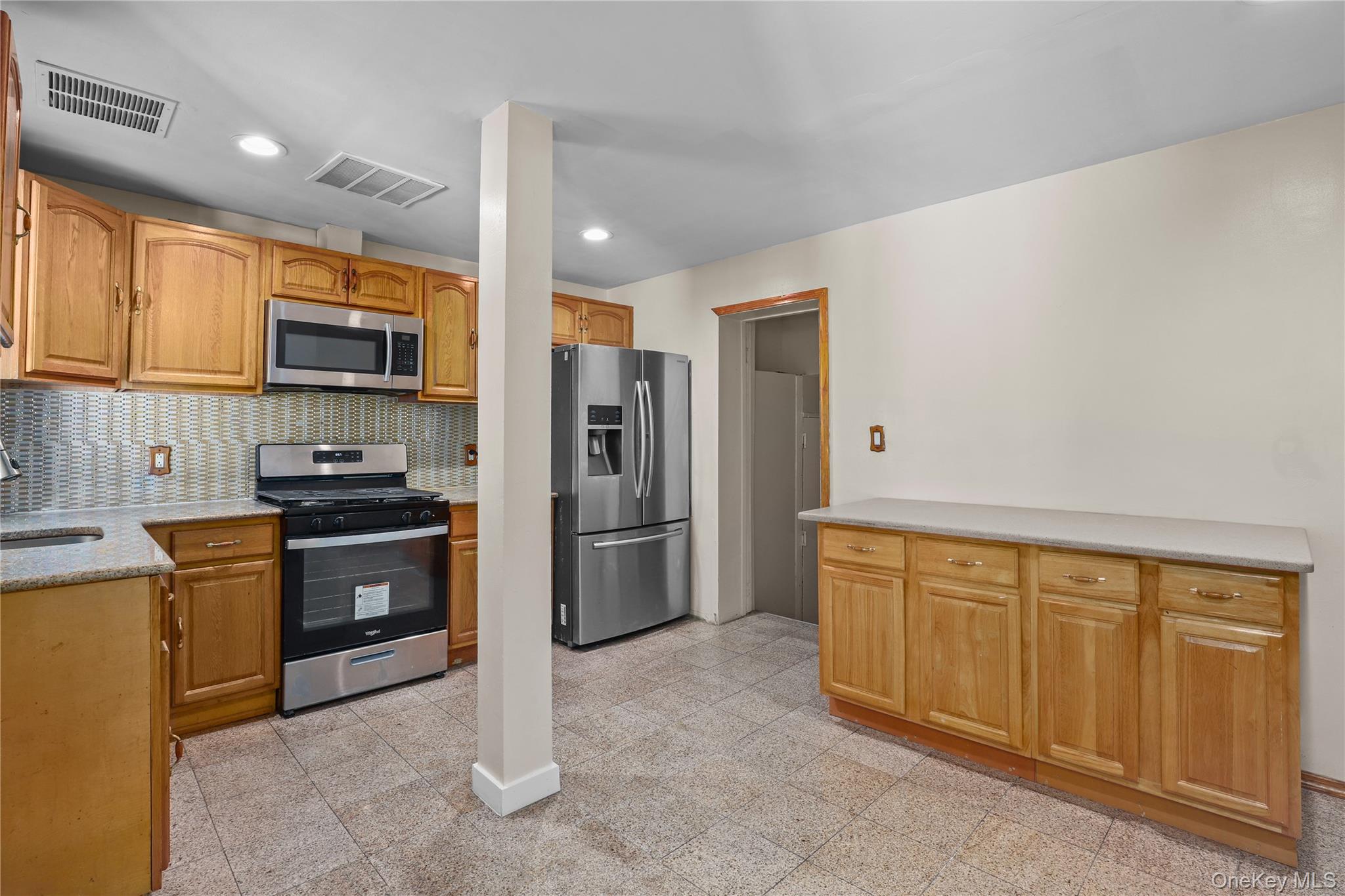 1448 Edwards Avenue Bronx, NY 10461 - Photo 7 of 28 a kitchen with stainless steel appliances granite countertop a refrigerator and a stove top oven