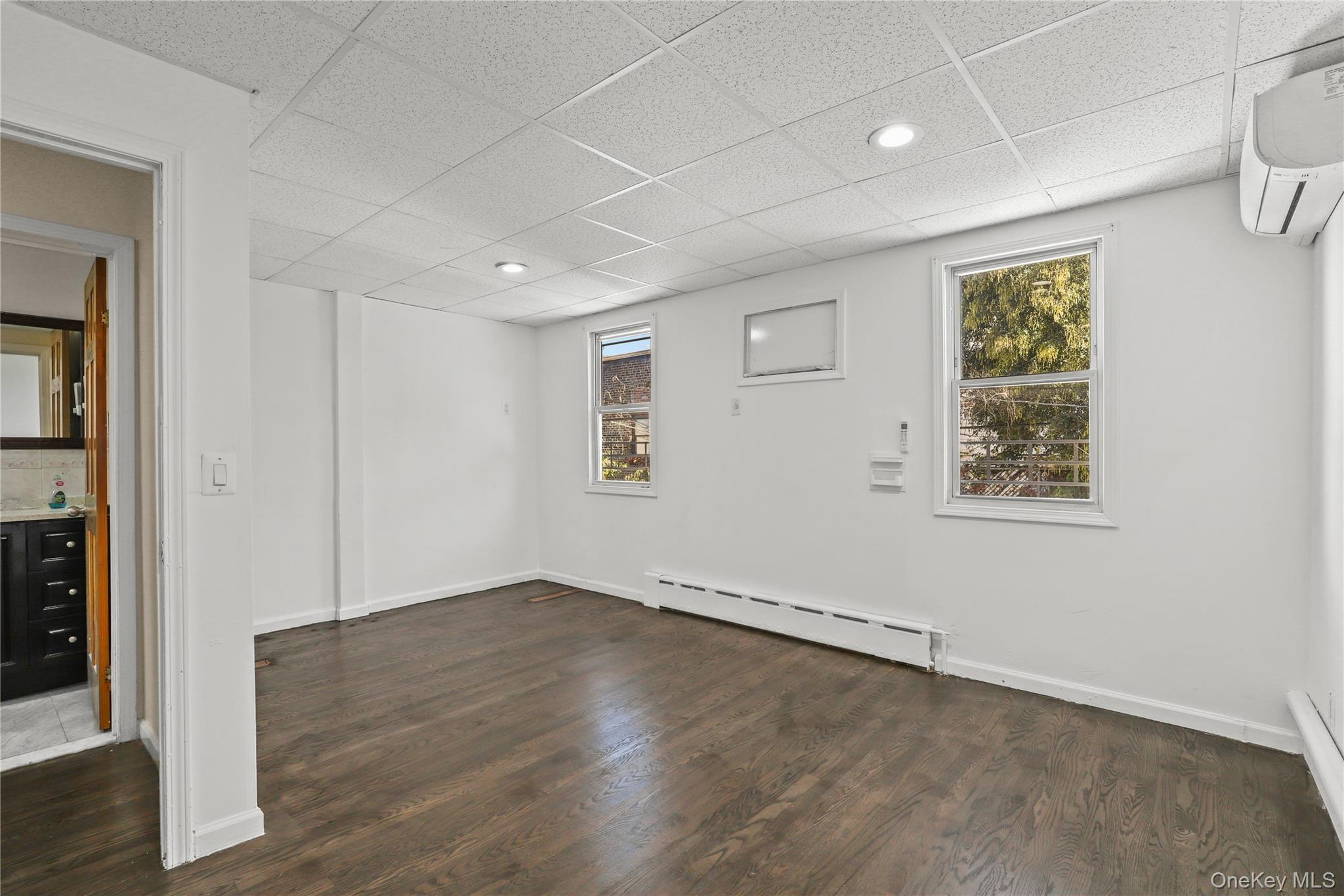 1448 Edwards Avenue Bronx, NY 10461 - Photo 9 of 28 an empty room with wooden floor and windows