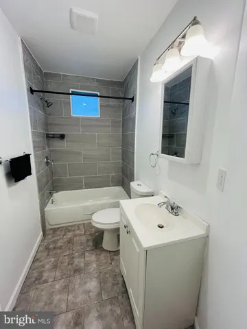 a bathroom with a sink a toilet and bathtub