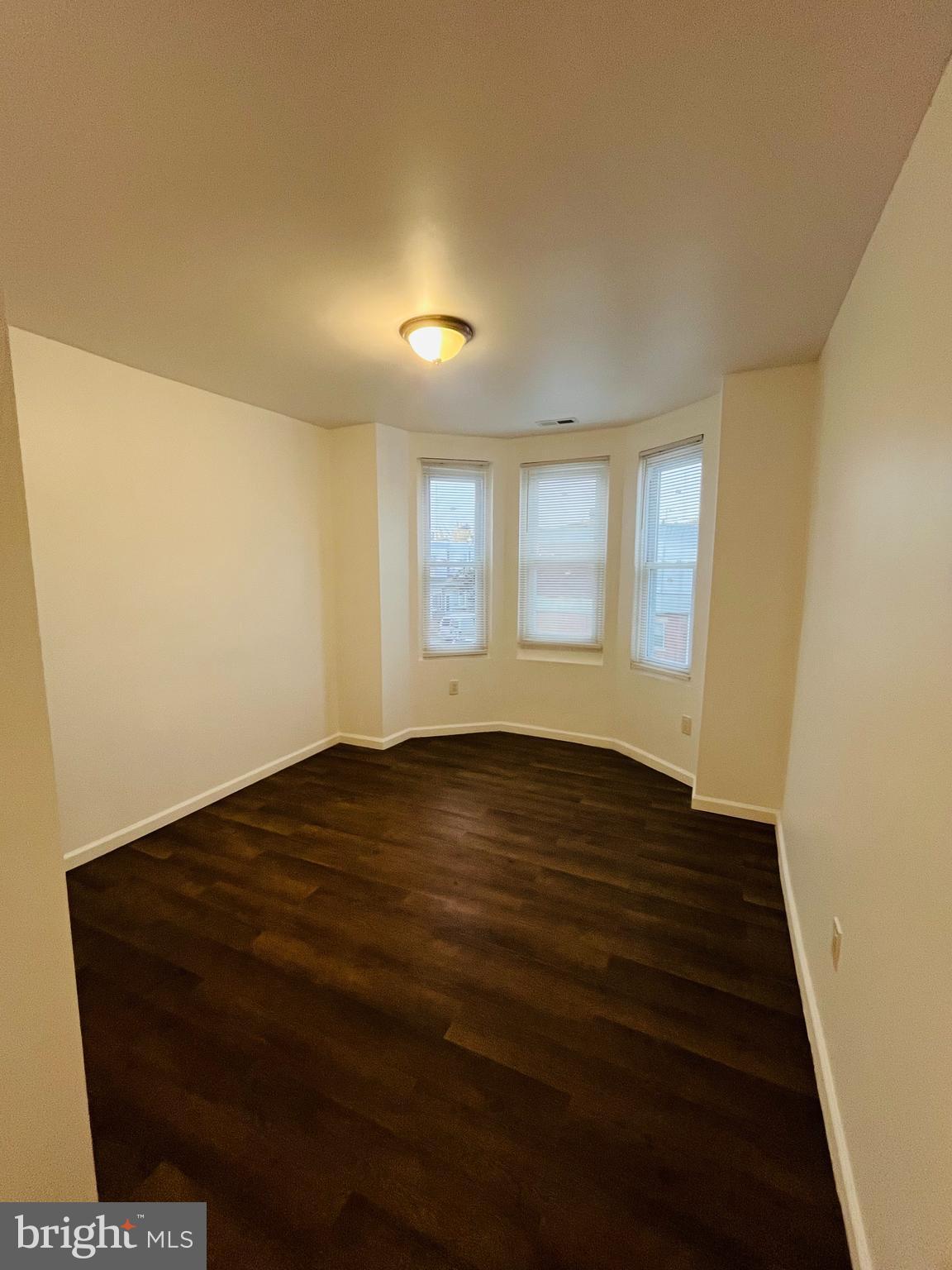 6249 Reedland Street, Unit 2 Philadelphia, PA 19142 - Photo 4 of 8 a view of an empty room with wooden floor and a window