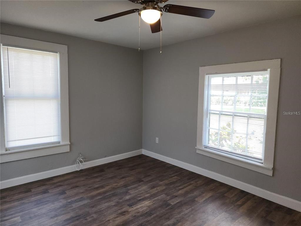 1339 7th Street Southwest Winter Haven, FL 33880 - Photo 7 of 11 a view of an empty room with wooden floor and a window
