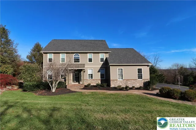 a view of a house with a yard and a garden