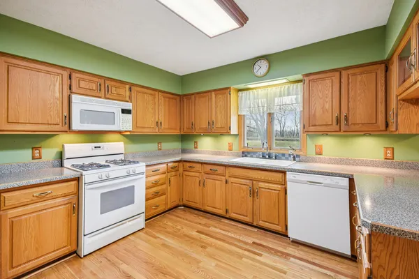 a kitchen with stainless steel appliances granite countertop a stove sink and cabinets