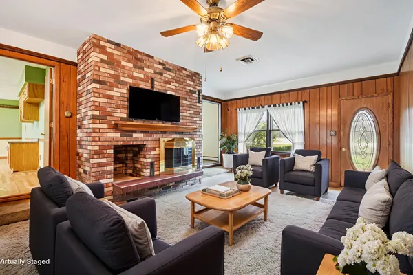 a living room with fireplace furniture and a flat screen tv