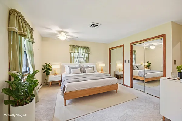 a spacious bedroom with a balcony a bed and a chandelier