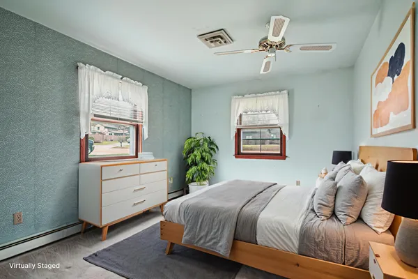 a bedroom with a bed and a window
