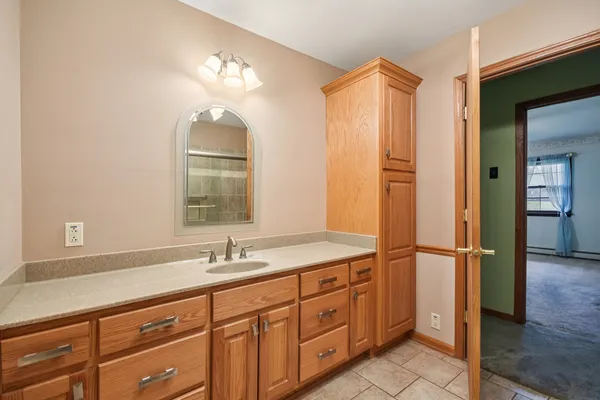 a bathroom with a double vanity sink and a mirror