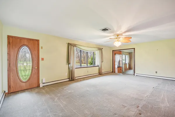an empty room with windows and closet