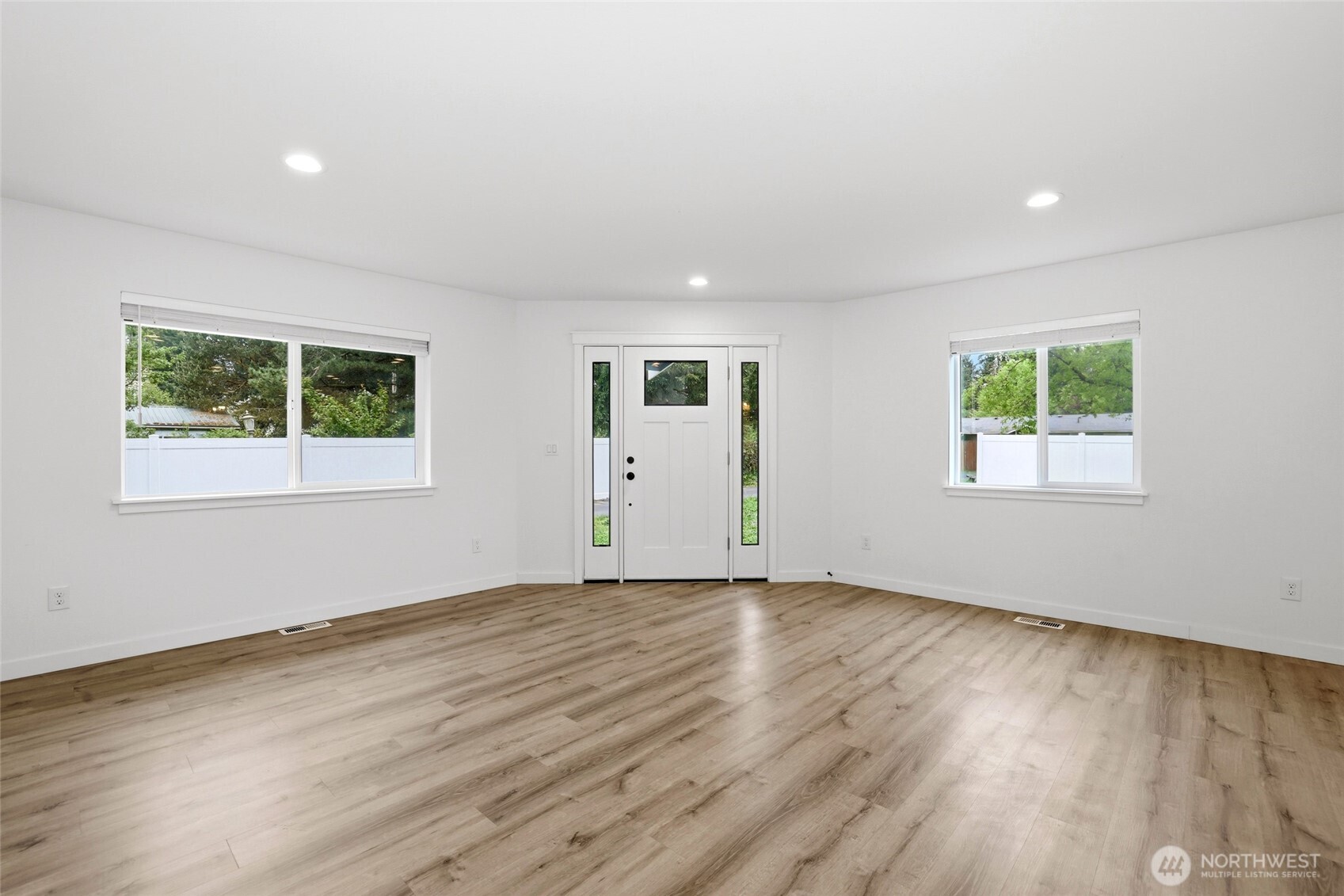9815 178th Way Southwest Rochester, WA 98579 - Photo 6 of 36 a view of an empty room with wooden floor and a window