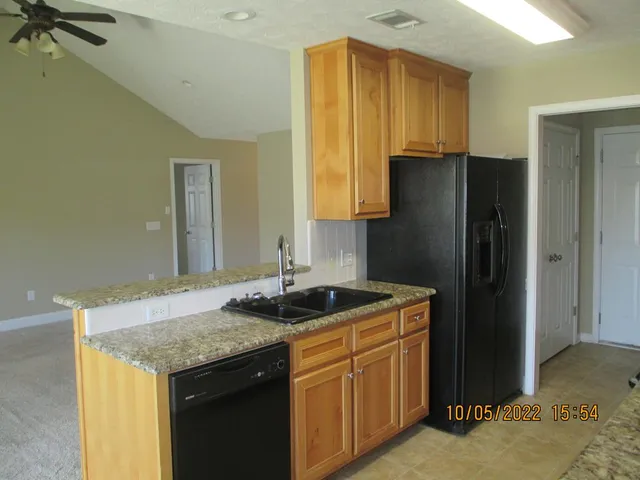 a kitchen with a sink and a refrigerator