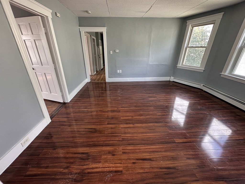 32 Ames Street Worcester, MA 01604 - Photo 5 of 21 wooden floor in an empty room with a window