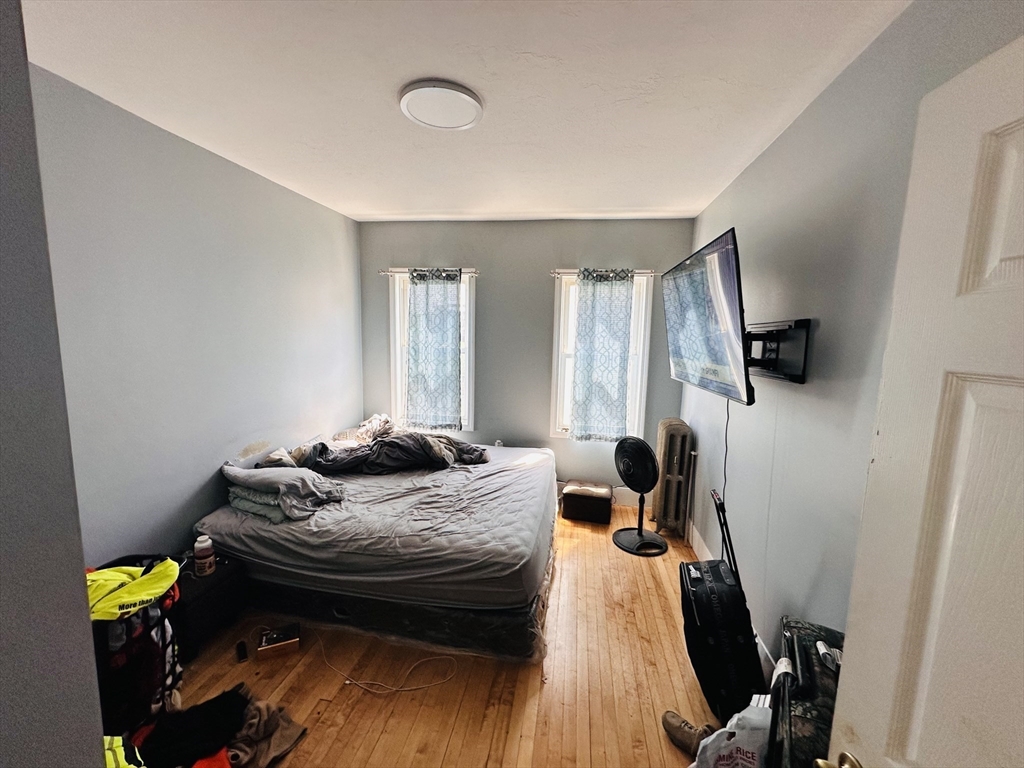 32 Ames Street Worcester, MA 01604 - Photo 6 of 21 a bedroom with a bed and wooden floor