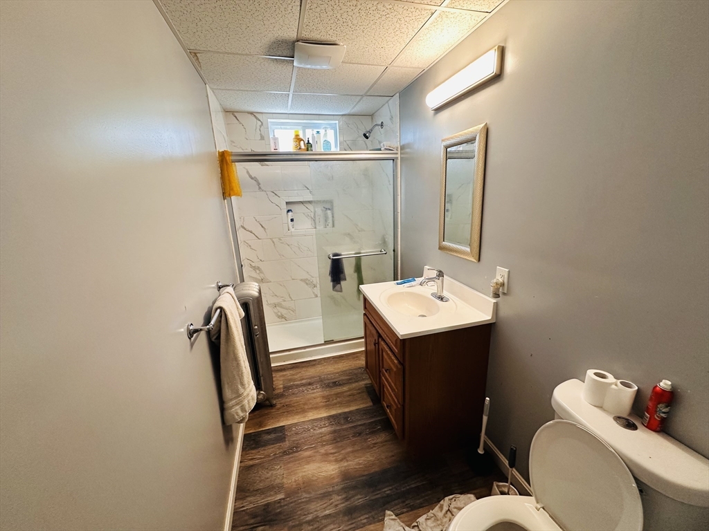 32 Ames Street Worcester, MA 01604 - Photo 9 of 21 a bathroom with a sink mirror vanity and toilet