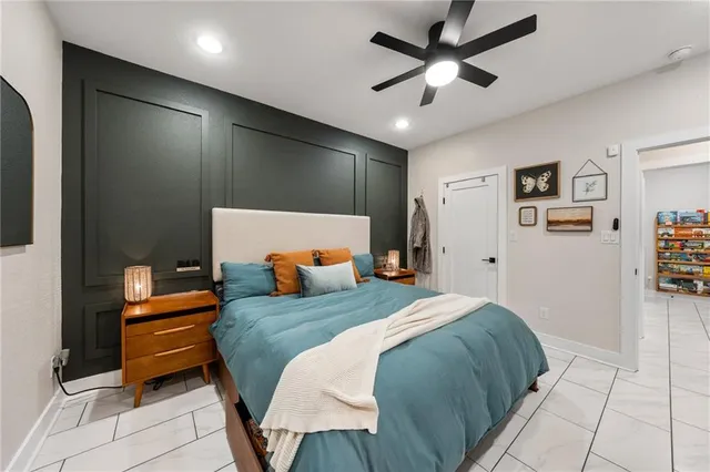 a bedroom with a bed and a ceiling fan