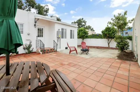a view of a patio with a table and chairs