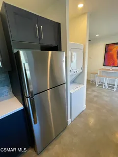 a refrigerator freezer sitting in a kitchen with stainless steel appliances granite countertop wooden cabinets and refrigerator
