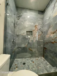 a bathroom with a sink toilet and mirror