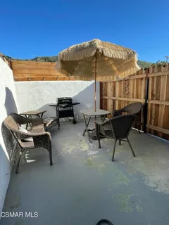 a terrace with outdoor seating and trees