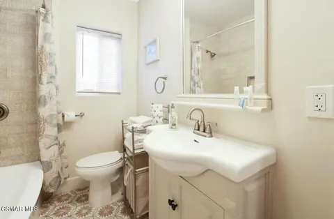 a bathroom with a sink toilet and mirror