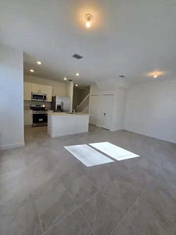 a view of kitchen and kitchen with a sink