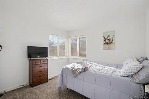 a bedroom with a bed and a television