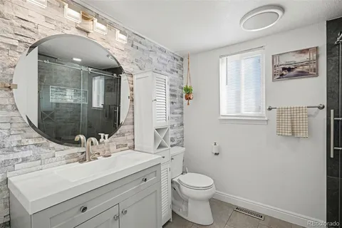 a bathroom with a sink toilet and shower