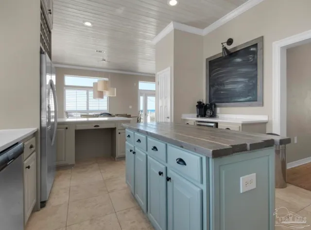 a kitchen with a sink a stove and cabinets