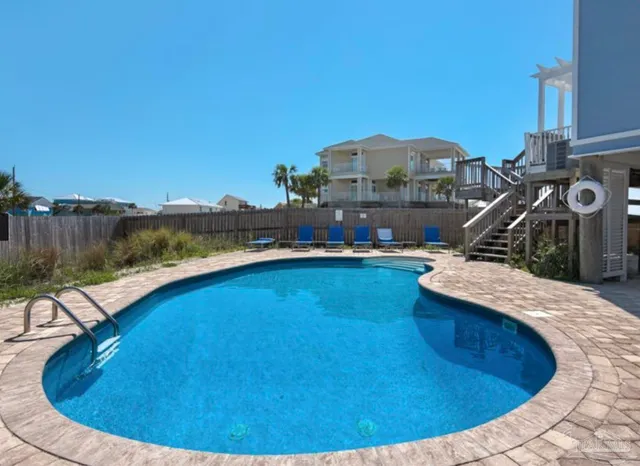 a front view of house with yard and swimming pool