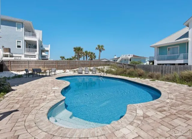 a view of a swimming pool with a lounge chairs