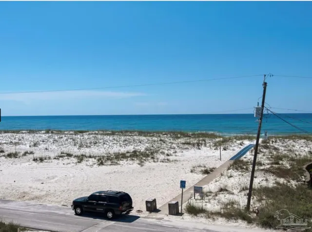 a view of a patio with couches table and chairs and potted plants