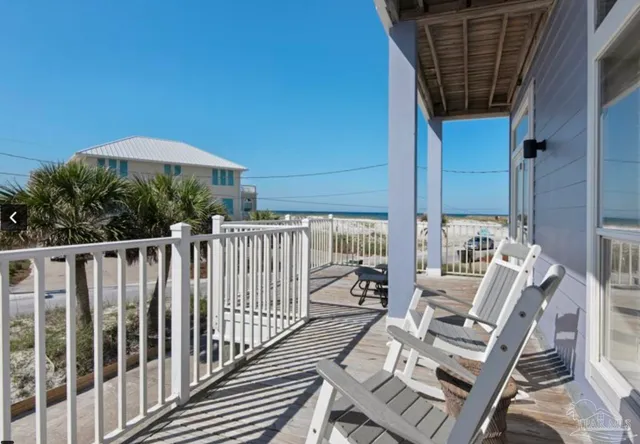 a view of a balcony with chair and wooden floor