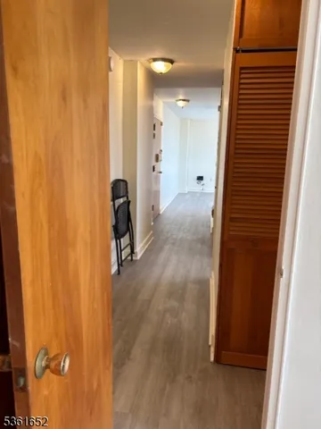 a view of hallway with wooden floor