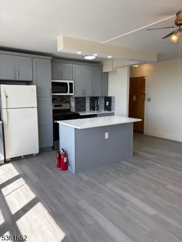 a kitchen with stainless steel appliances a refrigerator and a microwave