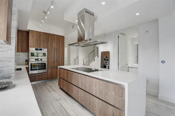 a kitchen with stainless steel appliances a sink stove and refrigerator
