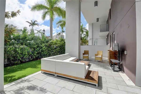 a building outdoor space with patio furniture and garden