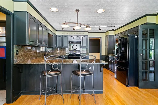 a dining room with furniture a chandelier and wooden floor