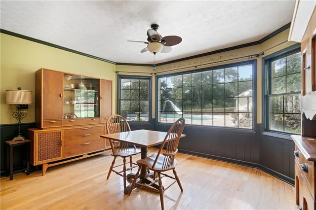 a view of a dining room with furniture window and wooden floor