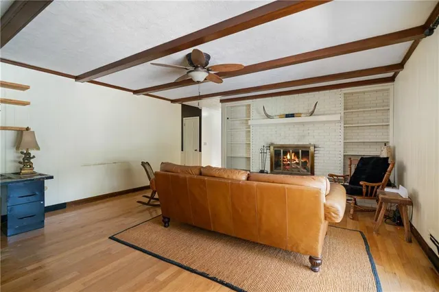 a living room with furniture and a floor to ceiling window
