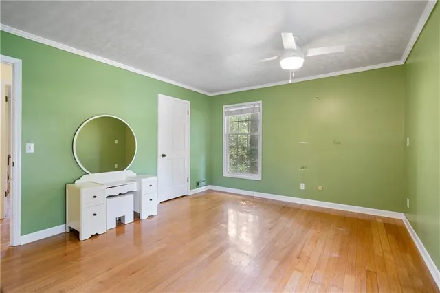 a large kitchen with stainless steel appliances a large counter top and wooden floors