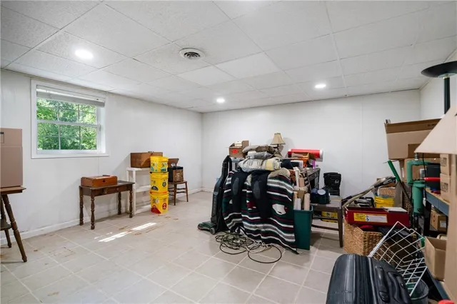 a living room filled with lots of furniture and a porch