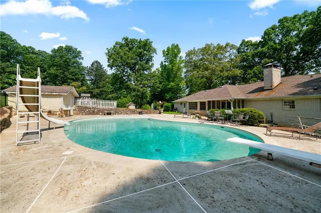 a backyard of a house with a yard and outdoor seating