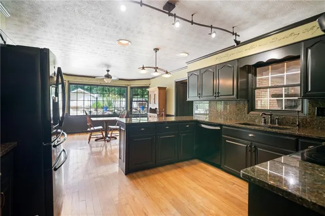 a kitchen with stainless steel appliances granite countertop a stove and a refrigerator