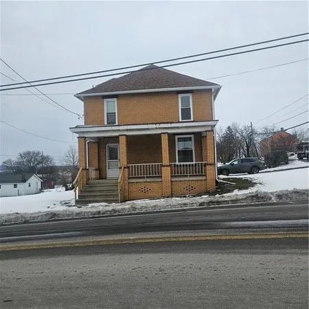 a view of a house with a small yard and large window