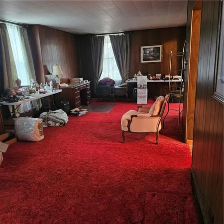 a living room with furniture rug and window